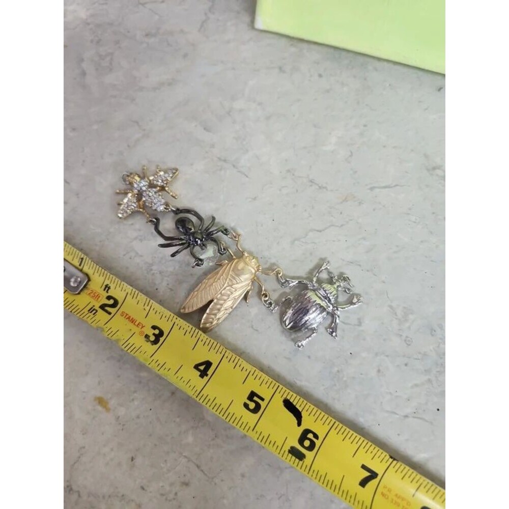 goth insect charms linked together